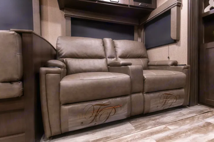 Plush recliners with cup holders provide comfort in this RV rental's living space. Features dark blinds & wood-look floor.. Grand Design Reflection 2021
