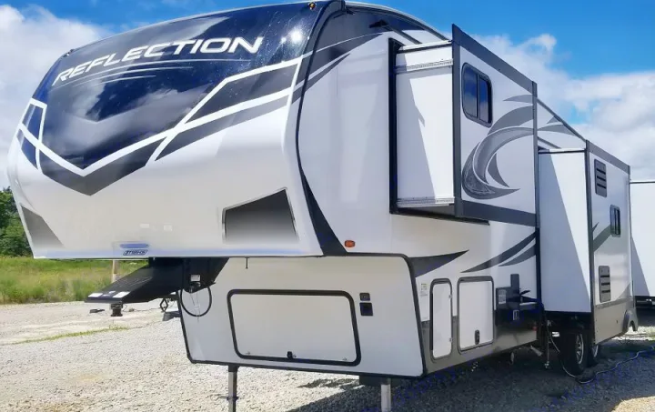 White fifth-wheel RV with extended slide-outs, black & grey graphics. An ideal option for an RV rental or camping trip.. Grand Design Reflection 2021