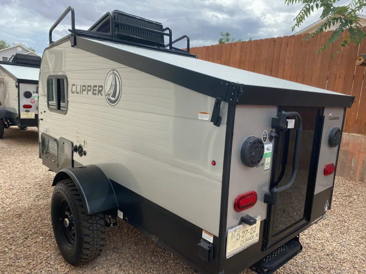 A grey Coachmen Clipper off-road camper, possibly an RV rental, parked on gravel with a Utah temporary plate visible.. Coachmen Clipper Express 9.0 TD 2022