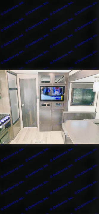 RV rental: View inside a modern RV showing the kitchenette, a TV entertainment center, and a dinette area.. Jayco Jay Flight 2022