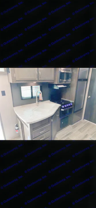 RV rental kitchen: light countertop, sink, microwave, stove with glowing knobs, fridge, and storage.. Jayco Jay Flight 2022