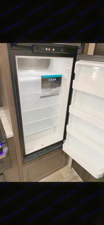 An RV rental's spacious and clean refrigerator, featuring wire shelves, awaits your provisions. Essential for any RV kitchen.. Jayco Jay Flight 2022