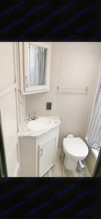 Clean RV rental bathroom featuring a vanity with sink, toilet, medicine cabinet with mirror, and shower area.. Jayco Jay Flight 2022