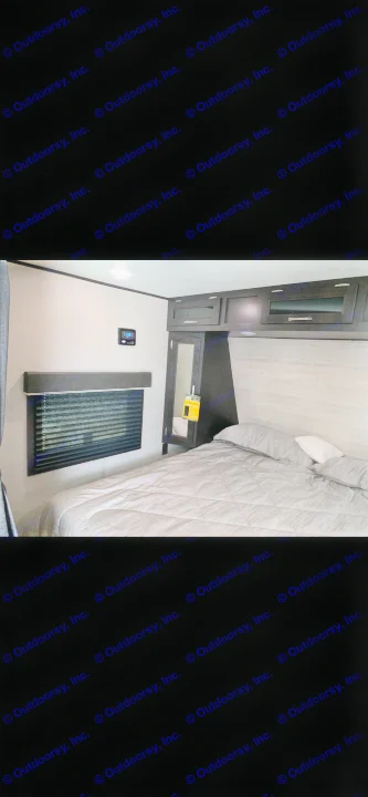 Comfortable RV rental bedroom featuring a grey bed, window with blinds, and ample overhead storage.. Jayco Jay Flight 2022