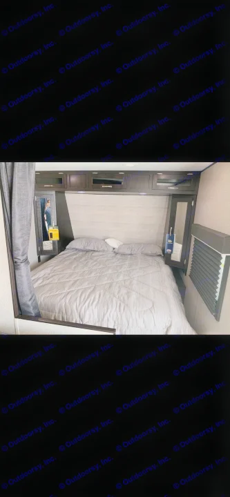 Cozy RV bedroom interior featuring a comfortable bed, overhead cabinets, and side mirrors, ideal for an rv rental.. Jayco Jay Flight 2022