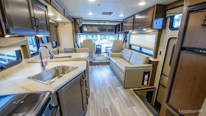 Spacious RV rental interior with modern kitchen, comfortable living area, and driver's cockpit visible.. Thor A.C.E. 2020