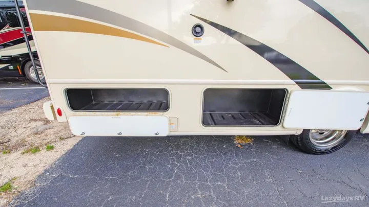 RV rental's side with two open exterior storage compartments, ready for all your travel gear.. Thor A.C.E. 2020