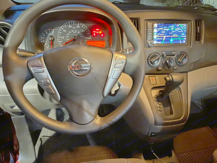 Nissan RV rental interior showing dashboard with 5219.3 miles, steering wheel, and navigation screen.. Nissan Elgrand 2021