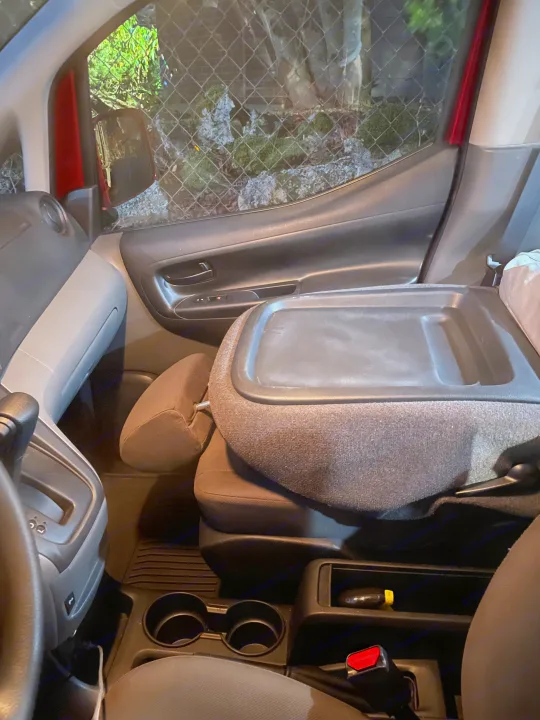 RV rental interior: passenger area featuring a fold-down tray on the back of a seat, ideal for dining or work during travel.. Nissan Elgrand 2021