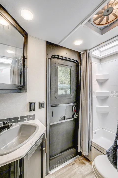 Bright, clean RV rental bathroom interior featuring a functional sink, shower/tub, and toilet. Perfect for your travels.. Cherokee 26DBH 2022