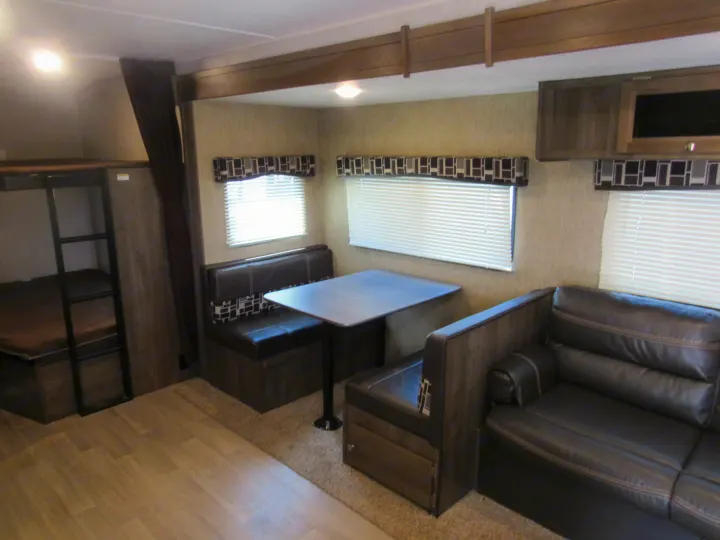 RV rental interior: a practical layout featuring bunk beds, a dinette, and a comfortable sofa.. Dutchmen Coleman Lantern 2017