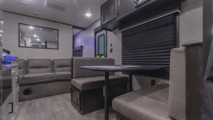 Modern RV rental interior with a comfortable sofa and dinette. Enjoy the spacious living and dining area.. Jayco Jay Flight SLX 2022