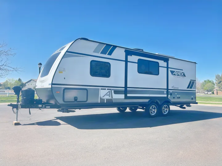 Sleek Apex Ultralite travel trailer, ideal for your next RV rental trip, parked on a clear day.. Coachmen Apex 2022