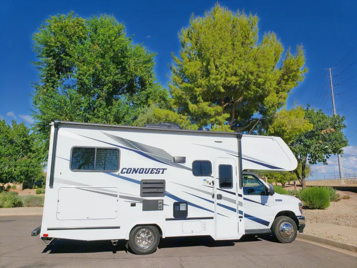 White Conquest Class C RV rental, parked on a sunny day. This motorhome is ready for your next adventure.. Gulf Stream Conquest 2022