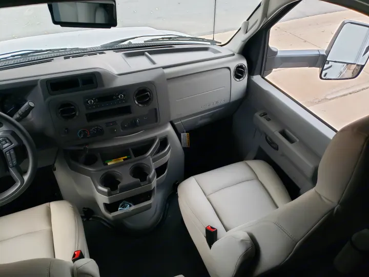 RV rental Ford E-Series van cabin interior, featuring dashboard, steering wheel & front seats. Ready for adventure.. Gulf Stream Conquest 2022