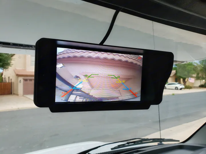 RV rental's backup camera view on a monitor, displaying a garage with parking lines to aid safe reversing.. Gulf Stream Conquest 2022