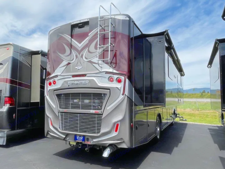 Rear view of a luxury Frontier RV motorhome for rental, dark gray with burgundy trim & slide-out extended.. Fleetwood Frontier 2023