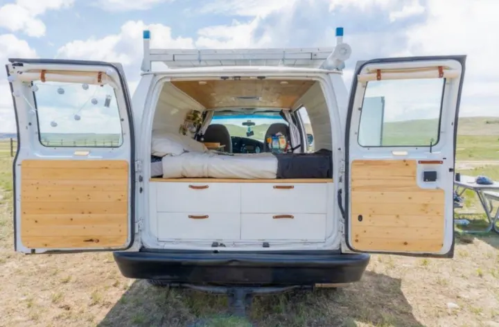 Explore van life! This converted camper van features a bed, drawers & wooden interior, perfect for an rv rental adventure.. Ford Econolline 250s 2008