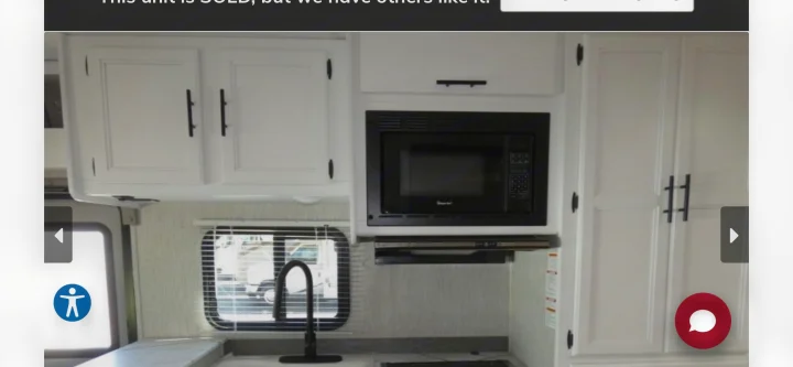 RV rental kitchen: This camper interior features white cabinets, a microwave, and a sink, perfect for on-the-road living.. Coachmen Cross Trail 2022