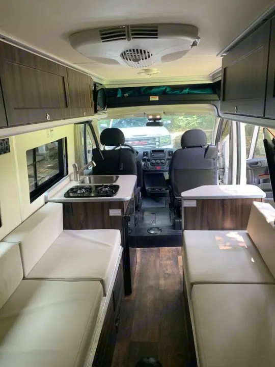 Inside an RV rental: a spacious camper van interior with kitchen, living/sleeping areas, and front cab view, ideal for travel.. Carado Carado Class B 2018