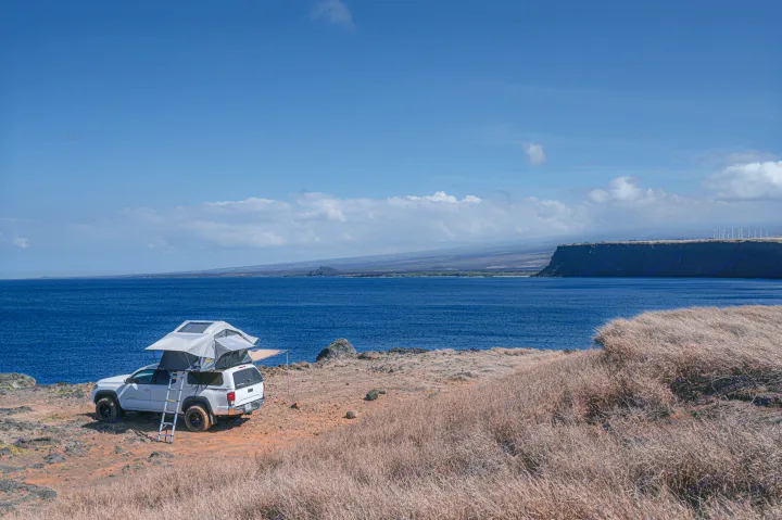 Rooftop tent **rv rental** on a white truck overlooks ocean & cliffs. Perfect for Hawaii adventure camping.. Custom Camper 2016