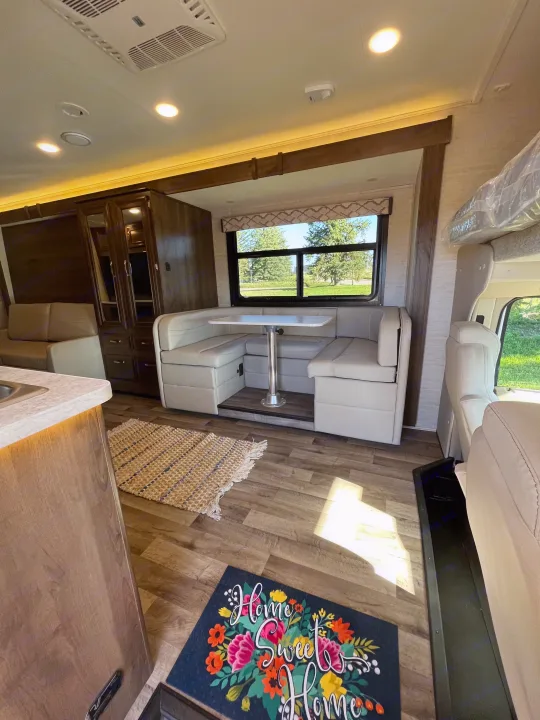RV rental: Bright, well-appointed interior with a comfortable dinette, kitchen counter, and sleeping bunk. Experience cozy mobile living.. Jayco Redhawk 2021