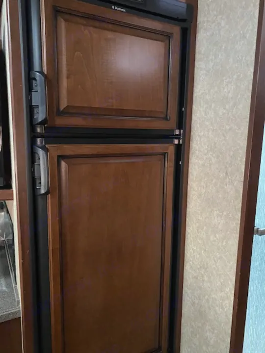 RV rental: Secure wooden Dometic refrigerator/freezer doors with travel latches, ideal for mobile living.. Tioga Fleetwood 2011