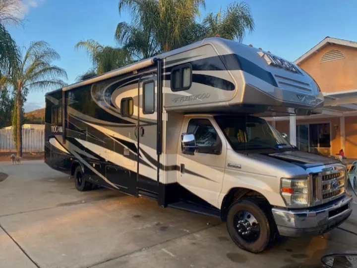 Spacious Class C Fleetwood Tochali RV, parked on a driveway, ready for your next RV rental adventure.. Tioga Fleetwood 2011