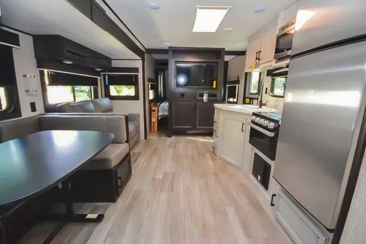 Enjoy this modern **rv rental** interior featuring a spacious living area, dinette, full kitchen, and bedroom access.. Jayco Jay Flight 2022