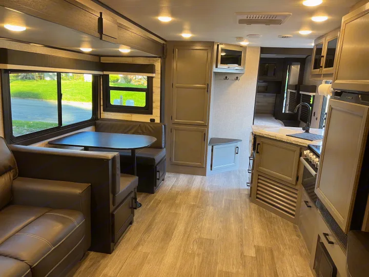 Spacious RV rental interior featuring a modern kitchen, dinette, and comfortable living area for travel.. Jayco Jay Feather 2022