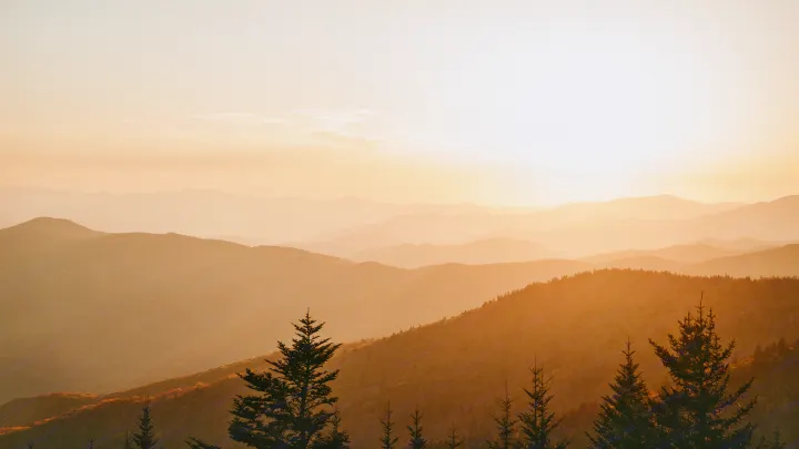 Golden sunset over layered mountains, with silhouetted pines. Perfect scenery for your RV rental adventure.. Jayco Jay 2015