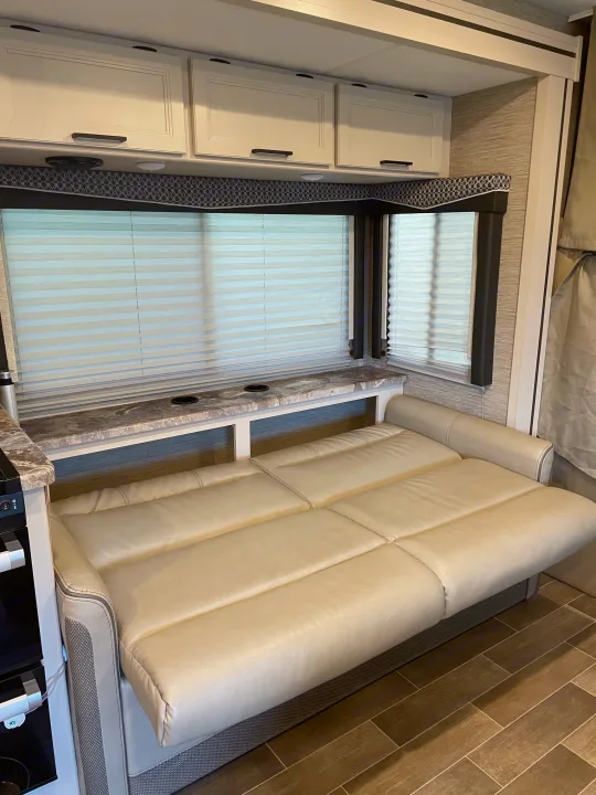 This RV rental offers a comfy pull-out sofa bed, practical countertop with cup holders, and large windows with blinds.. Thor Chateau 2022