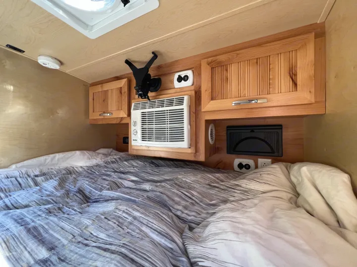 Experience comfort in this RV rental! Features include a cozy bed, wooden cabinets, AC, and charging station for your travels.. Little Guy Silver Shadow 2016