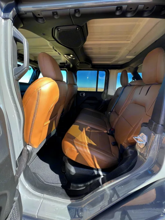 Spacious tan leather interior of a 4x4 SUV, with rear seats & hardtop. Consider this for your next RV rental adventure.. Jeep Wrangler 2022