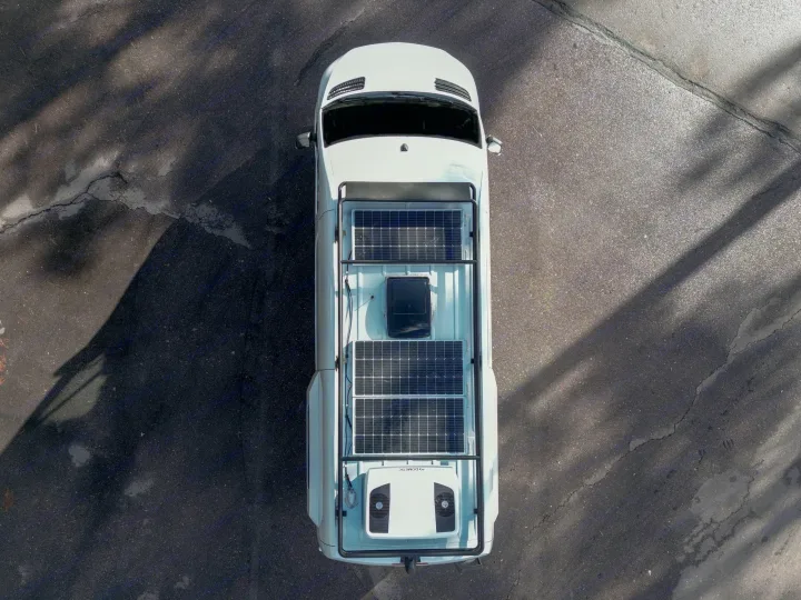 White camper van RV rental with rooftop solar panels & AC unit on asphalt.. Mercedes-Benz Sprinter RV Motorhome Campervan 2022