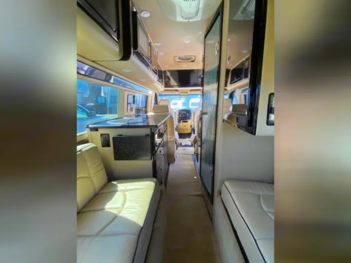 Explore this premium RV rental's interior: a spacious camper van with kitchen, comfortable seating, and sleeping areas.. Mercedes Sprinter 2015