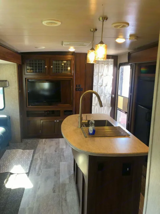 Modern RV rental interior featuring a full kitchen island, entertainment center, and spacious living area.. Heartland RVs Mallard 2019