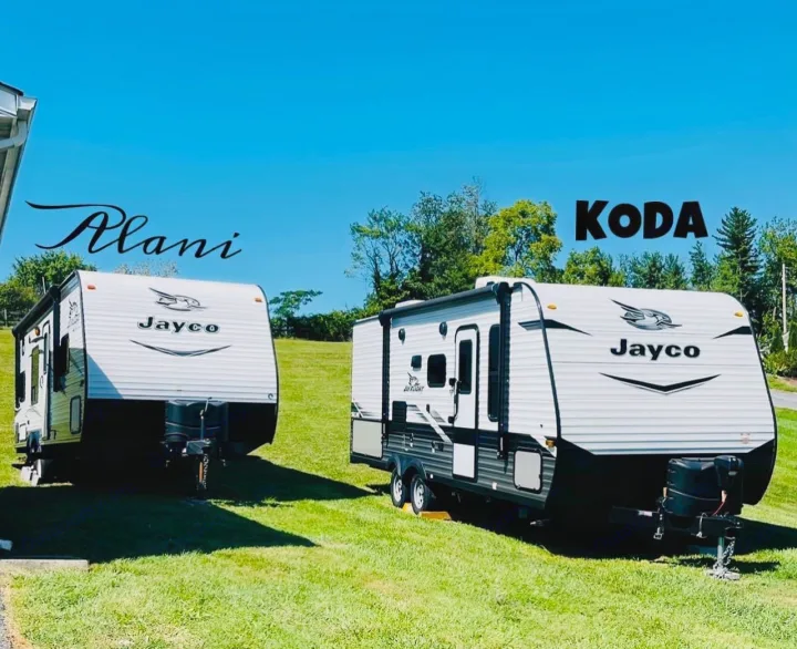Two Jayco travel trailers, "Alani" and "Koda", parked on grass under a clear sky. Perfect for your next RV rental adventure!. Jayco Jay Flight 2017