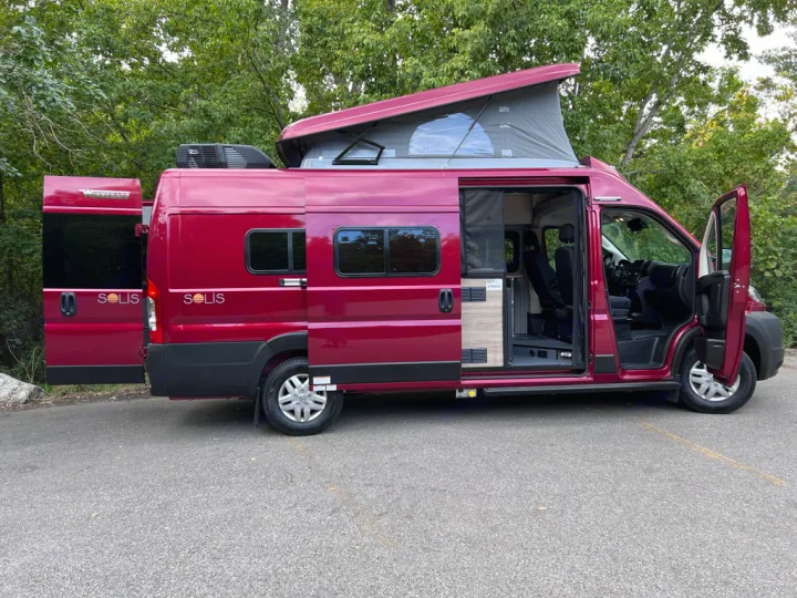 Red Winnebago Solis camper van for rv rental, with pop-top open, ready for adventure.. Winnebago Solis 59PX 2023
