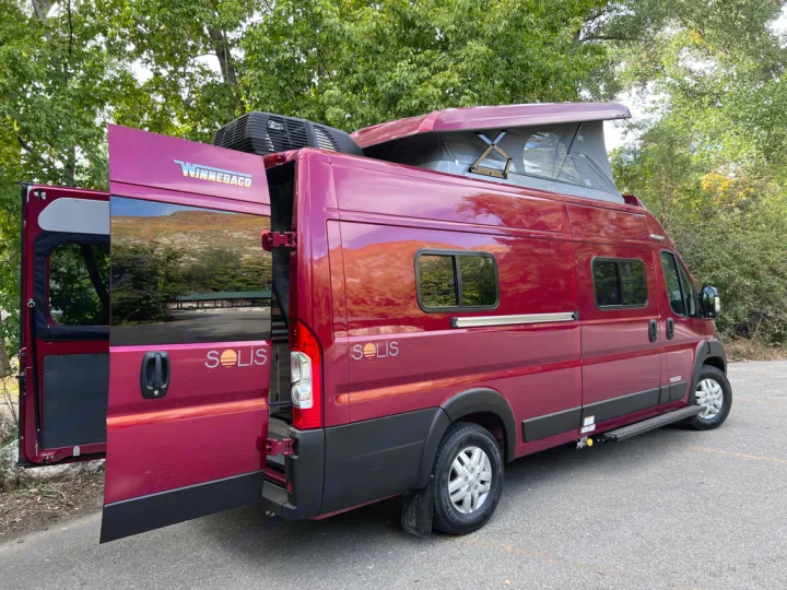 Maroon Winnebago Solis camper van with pop-top roof and open rear doors. Perfect for an RV rental adventure!. Winnebago Solis 59PX 2023