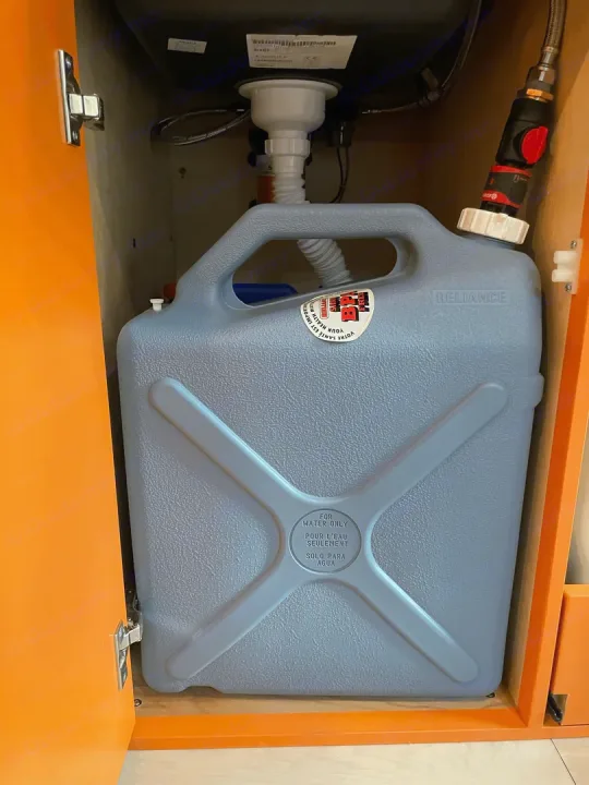 RV rental under-sink grey water tank: A Reliance water container for wastewater collection, vital for mobile living.. Ford Extended E350 2011