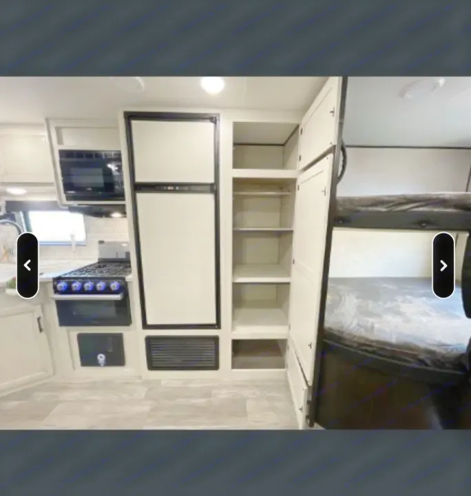 Spacious RV rental interior featuring a modern kitchen, fridge, ample storage, and comfortable bunk beds for travel comfort.. Jayco Jay Flight SLX Rocky Mountain Edition 2022