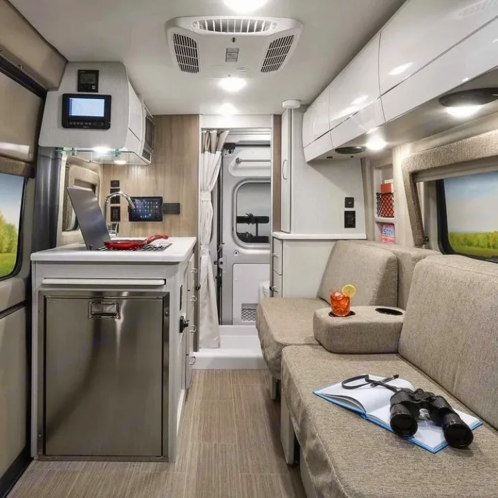 This modern rv rental showcases a compact kitchen, comfortable lounge area, and efficient rear shower space.. Thor Rize 2022