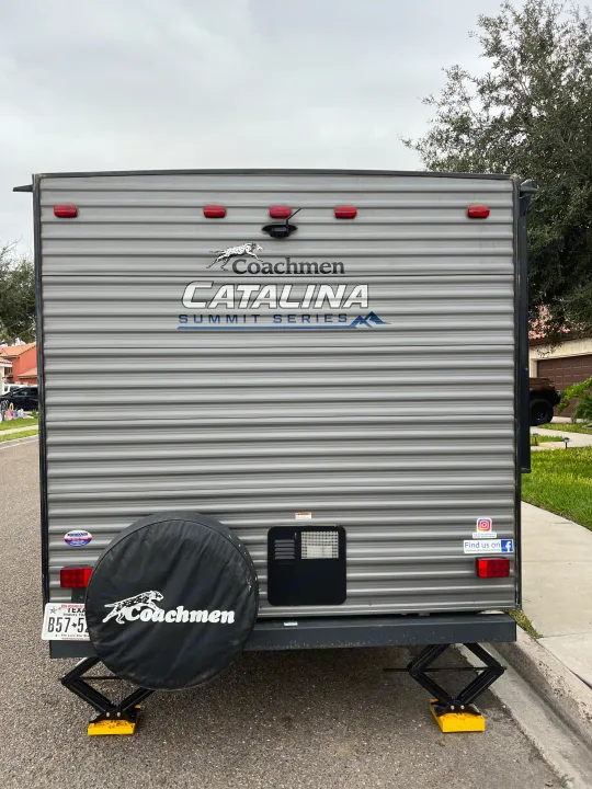 Rear of a grey Coachmen Catalina rv rental with spare tire & stabilizer jacks. Perfect for your next #RVlife #Travel.. Coachman Catalina Catalina Summit Series 7 184BHS 2022