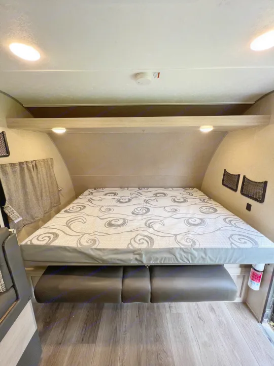 This RV rental offers a convertible bed/dinette area, complete with a patterned mattress, overhead lights, and handy storage nets.. Coachman Catalina Catalina Summit Series 7 184BHS 2022