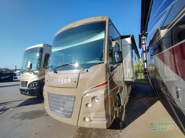 View this tan Winnebago RV motorhome, great for rv rental or purchase, parked alongside another on a sunny lot.. Winnebago Vista 2017