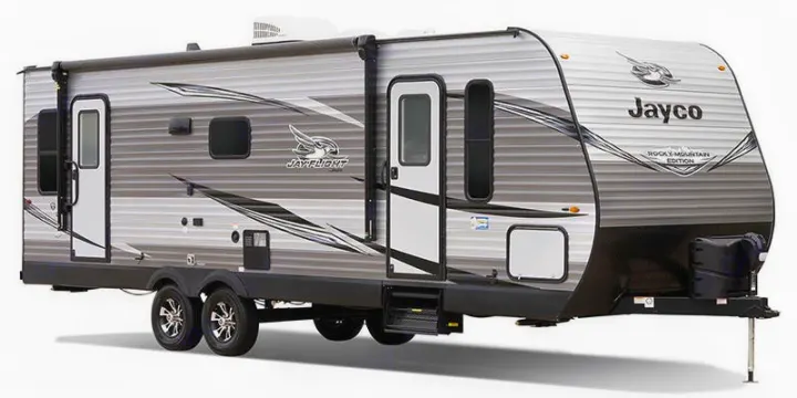 This gray Jayco travel trailer, perfect for RV rental, features an awning, two doors, and multiple windows.. Jayco Jay Flight SLX Rocky Mountain Edition 2021
