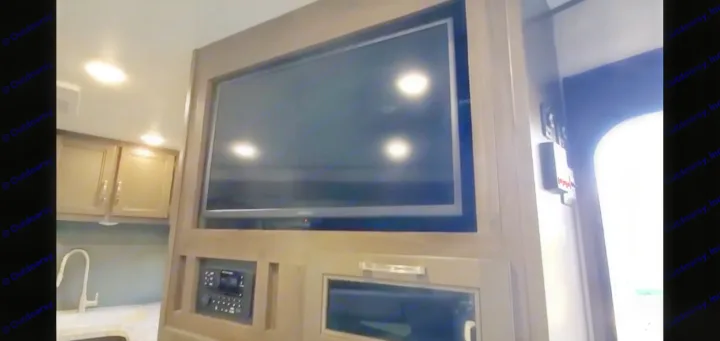 Explore this RV rental's cozy interior, featuring a built-in TV, media center, and compact kitchen area.. Jayco Jay Flight SLX Rocky Mountain Edition 2021
