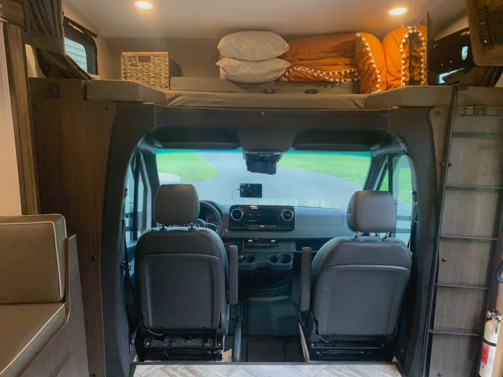 RV rental: Interior view from the living space, showing the front cab with two seats and an overhead sleeping bunk.. Forest River Sunseeker 2022