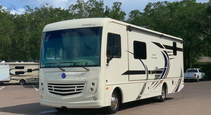 This white Holiday Rambler Admiral motorhome, parked in a lot, is ideal for your next rv rental adventure.. Holiday Rambler Admiral 2021